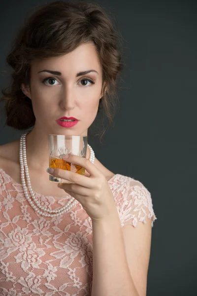 Vintage portrait of woman holding a drink — Stock Photo, Image