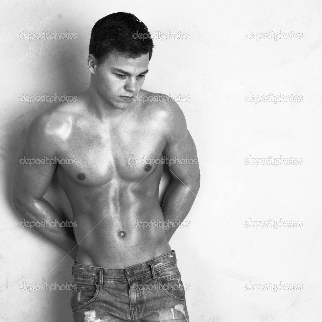 Image of young shredded man against a wall
