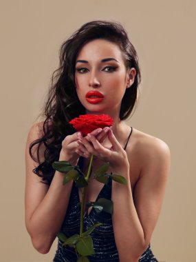 kırmızı bir gül ile küçük siyah elbiseli seksi kız