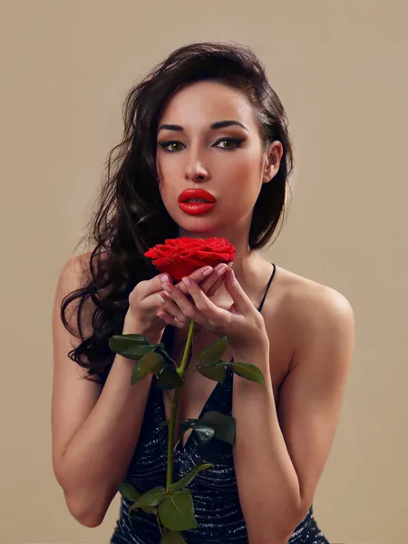 Sexy girl in little black dress with a red rose — Stock Photo, Image