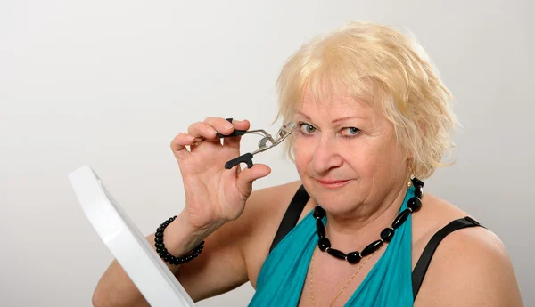 Woman using eyelash curler — Stock Photo, Image