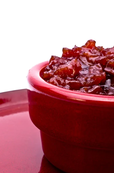 Closeup of a jar of jam on a red plate — Stock Photo, Image