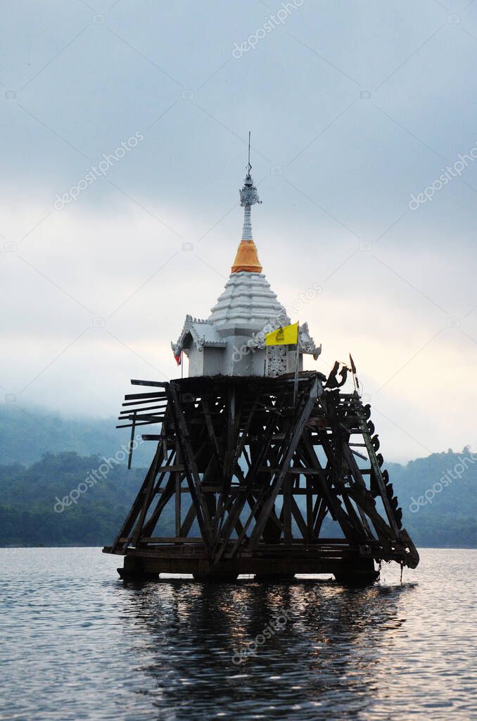 Ancient antique ruins ubosot of Wat Sri Suwan drown deep underwater of Songkalia river at sunset dawn time for thai people and foreign travelrs travel visit at Sangkhla Buri in Kanchanaburi, Thailand