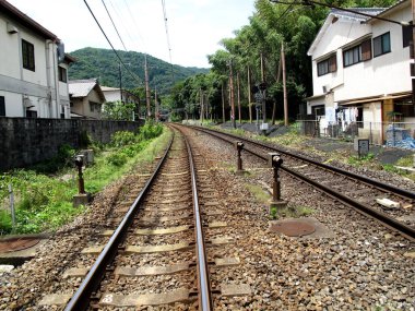 Railway track of Sagano Torokko romantic train for japanese people and foreign travelers travel visit Arashiyama scenic beauty mountain hill forest and oi river at Kyoto city in Kansai region, Japan
