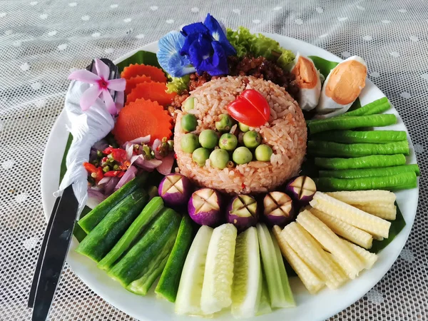 Traditional local thai southern food Stir fried chilli dip fried rice with chili paste served with sweet pork and salted egg and variety vegetable on dish plate at restaurant shop in Bangkok, Thailand