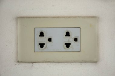 Classic power socket or old electrical outlet on white wall for thai people use energy electricity in Wat Bot Bon temple at Bang Kruai city  in Nonthaburi, Thailand