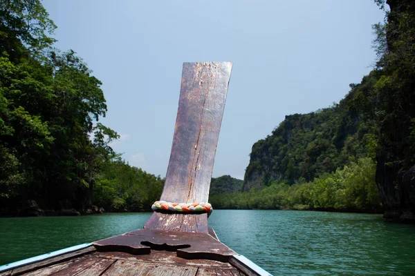 Local thai people guide riding sailing wooden longtail boat in sea ocean bring travelers travel visit tour Ko Khao Yai and Prasat Hin Pan Yod and San Lang Mangkorn at La ngu city of Satun, Thailand