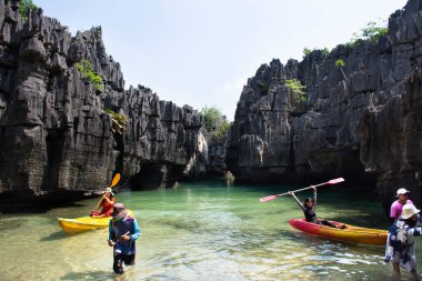 Thai people traveler paddle canoe boat of trip tour in sea ocean travel visit Ko Khao Yai and Prasat Hin Pan Yod in Mu Ko Petra National Park at Pak Bara in La ngu on April 12, 2022 in Satun, Thailand