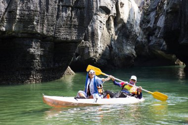 Local thai people guide paddle canoe boat of trip tour in sea ocean bring travelers women travel visit Prasat Hin Pan Yod in Mu Ko Petra National Park at Pak Bara on April 12, 2022 in Satun, Thailand