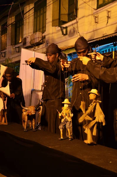 Thai professional puppeteer or Puppet master manipulate playing acting ancient puppets toy or antique marionette on stage for show in night festival event at SamYan on May 22, 2011 in Bangkok Thailand