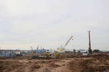 Asian labor people and thai labour worker use machine and heavy machinery working builder railway track electric sky train at construction site building on scaffold at capital city in Bangkok Thailand