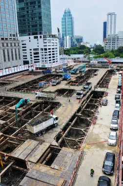 Asian labor people and thai labour worker use machine and heavy machinery working builder railway track electric sky train at construction site building on scaffold at capital city in Bangkok Thailand