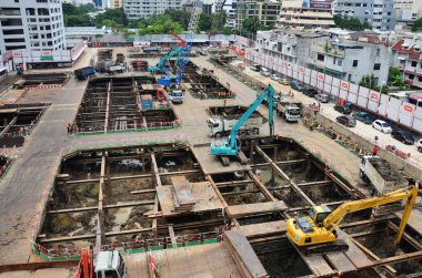 Asian labor people and thai labour worker use machine and heavy machinery working builder railway track electric sky train at construction site building on scaffold at capital city in Bangkok Thailand