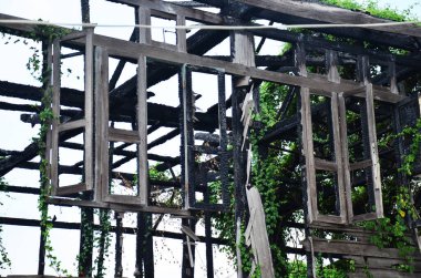 Exterior structure broken damaged of outdoor abandoned wooden antique building from old wood house fire at village in Bangkok, Thailand