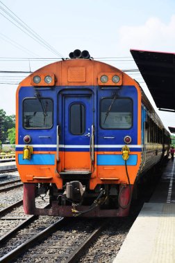 Local bogie locomotive train on track railway stop waiting for send receive thai people and foreign travelers passengers journey go to destination at phra nakhon si ayutthaya city in Bangkok, Thailand