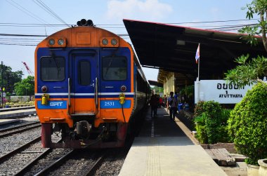 Local bogie locomotive train on track railway for send receive thai people and foreign travelers passengers journey go to destination at phra nakhon si ayutthaya on May 1, 2014 in Bangkok, Thailand