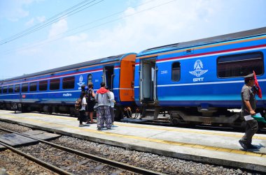 Local bogie locomotive train on track railway for send receive thai people and foreign travelers passengers journey go to destination at phra nakhon si ayutthaya on May 1, 2014 in Bangkok, Thailand
