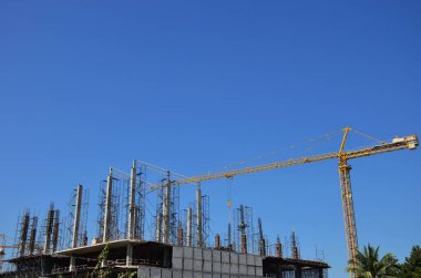 Asian labor people and thai labour workers use machine and heavy machinery working builder new structure tower high-rise building on scaffold at construction site at capital city in Bangkok, Thailand