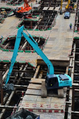 Asian labor people and thai labour workers use machine and heavy machinery working builder new structure tower high-rise building on scaffold at construction site at capital city in Bangkok, Thailand
