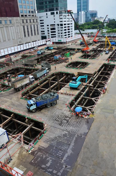 Asian labor people and thai labour workers use machine and heavy machinery working builder new structure tower high-rise building on scaffold at construction site at capital city in Bangkok, Thailand