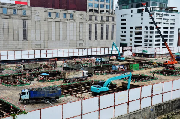 Asian labor people and thai labour workers use machine and heavy machinery working builder new structure tower high-rise building on scaffold at construction site at capital city in Bangkok, Thailand