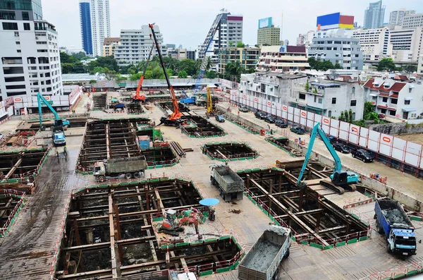 Asian labor people and thai labour workers use machine and heavy machinery working builder new structure tower high-rise building on scaffold at construction site at capital city in Bangkok, Thailand