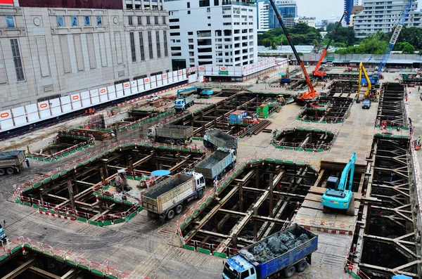 Asian labor people and thai labour workers use machine and heavy machinery working builder new structure tower high-rise building on scaffold at construction site at capital city in Bangkok, Thailand