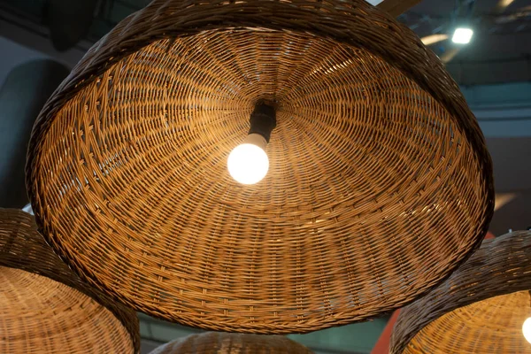 Interior decoration furniture and lighting ceiling hanging lamp with bamboo wicker weave on roof in room of classic retro vintage coffee shop for travelers travel visit and relax in Bangkok, Thailand