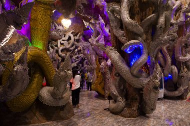 Tay halkı için yeraltındaki tünel naka mağarası 6 Eylül 2022 'de Nakhon Nayok Tayland' da Wat Maniwong tapınağındaki mistik antik Naga heykelini ziyaret edin ve dua edin.