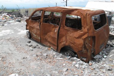 Burnt car wreck after volcano eruption clipart