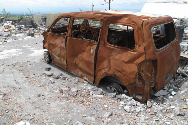 Burnt car wreck after volcano eruption