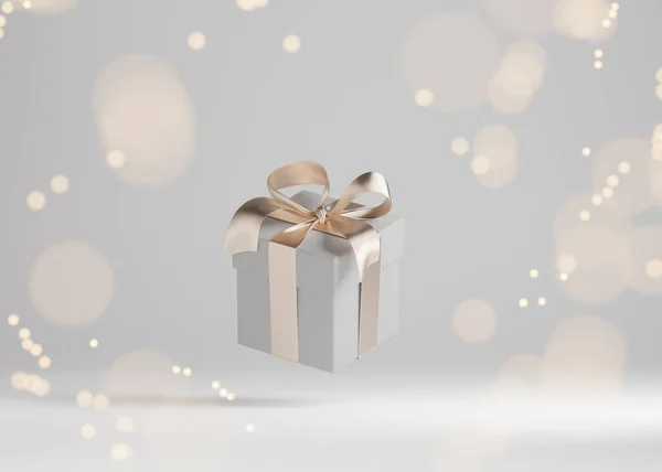 White Gift Box Golden Ribbon Bow Levitating Gray Background Flying Stock Picture