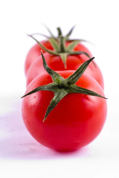 Three fresh cherry tomatoes — Stock Photo, Image