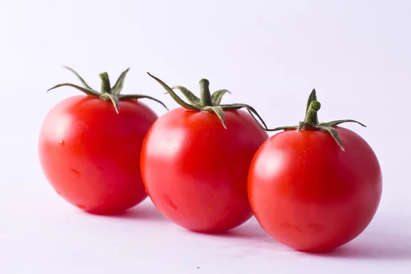 Three fresh cherry tomatoes — Stock Photo, Image