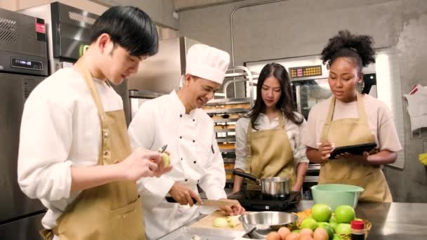 Hobby Kochkurs Seniorchef Kochuniform Bringt Jungen Kochkursteilnehmern Bei Äpfel Schälen — Stockvideo