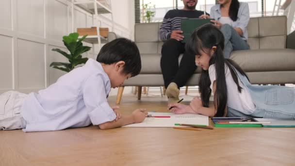 Asian Thai Siblings Lying Living Room Floor Drawing Homework Colored — Stock Video