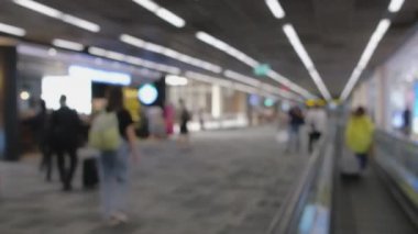 Wide blurred footage: People walking at pedestrian walkway, hurrying at boarding gate at Don Mueang International Airport terminal, Journey to travel destinations with luggage at departure lobby hall.