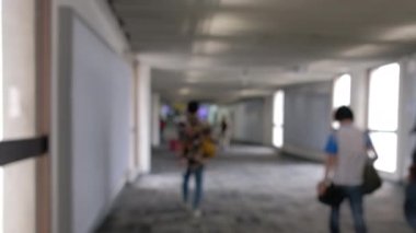 Wide blurred footage: People walking at pedestrian walkway, hurrying at boarding gate at Don Mueang International Airport terminal, Journey to travel destinations with luggage at departure lobby hall.