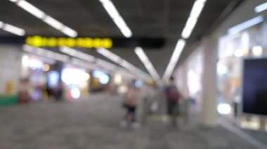 Wide blurred footage: People walking at pedestrian walkway, hurrying at boarding gate at Don Mueang International Airport terminal, Journey to travel destinations with luggage at departure lobby hall.