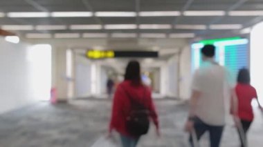 Wide blurred footage: People walking at pedestrian walkway, hurrying at boarding gate at Don Mueang International Airport terminal, Journey to travel destinations with luggage at departure lobby hall.