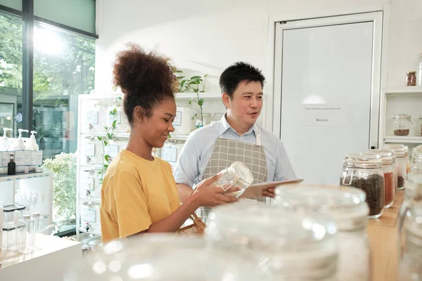 Asian Male Shopkeeper Describes Natural Organic Products Woman Customer Refill — Stockfoto