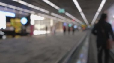 Wide blurred footage: People walking at pedestrian walkway, hurrying at boarding gate at Don Mueang International Airport terminal, Journey to travel destinations with luggage at departure lobby hall.