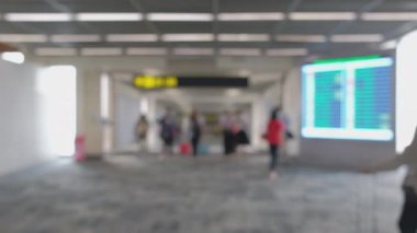 Wide blurred footage: People walking at pedestrian walkway, hurrying at boarding gate at Don Mueang International Airport terminal, Journey to travel destinations with luggage at departure lobby hall.