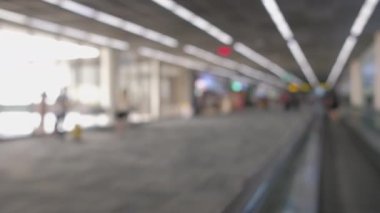 Wide blurred footage: People walking at pedestrian walkway, hurrying at boarding gate at Don Mueang International Airport terminal, Journey to travel destinations with luggage at departure lobby hall.