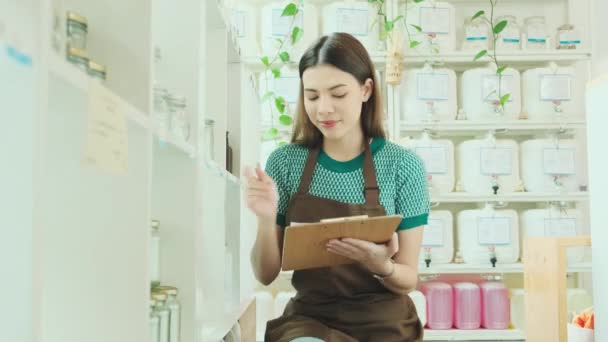 White Female Shopkeeper Checks Stock Natural Organic Products Retail Display — Stock Video