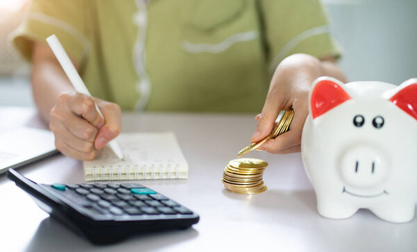Asian woman calculating her savings