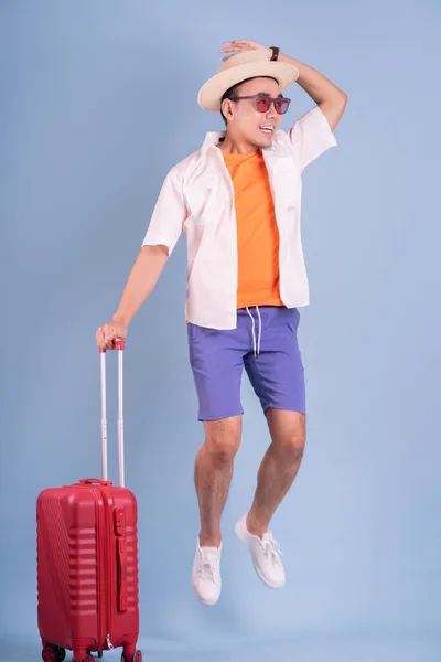 Young Asian Man Holding Red Suitcase Blue Background — Stock Photo, Image