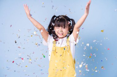 Portrait of Asian child posing on blue background