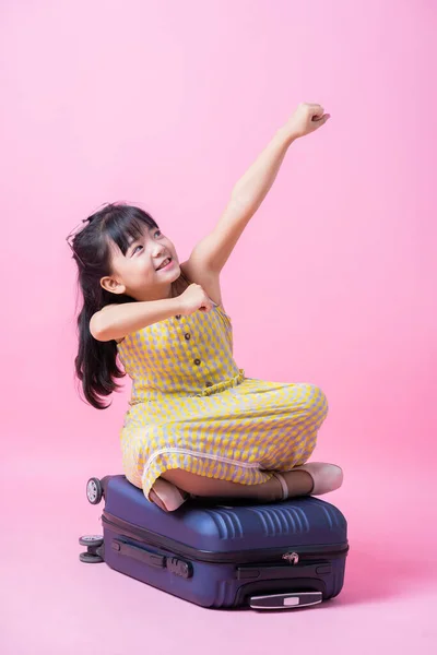 Image of Asian child with suitcase, summer concept