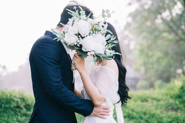 Image of young Asian bride and groom